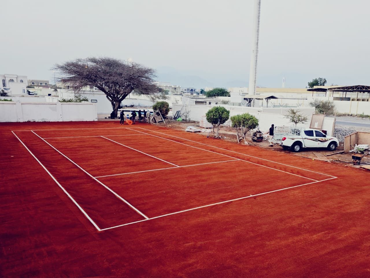 Red clay tennis court with fresh white line marking