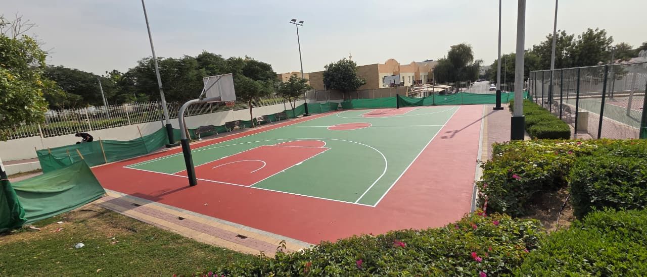 Green and red acrylic basketball court with white line marking