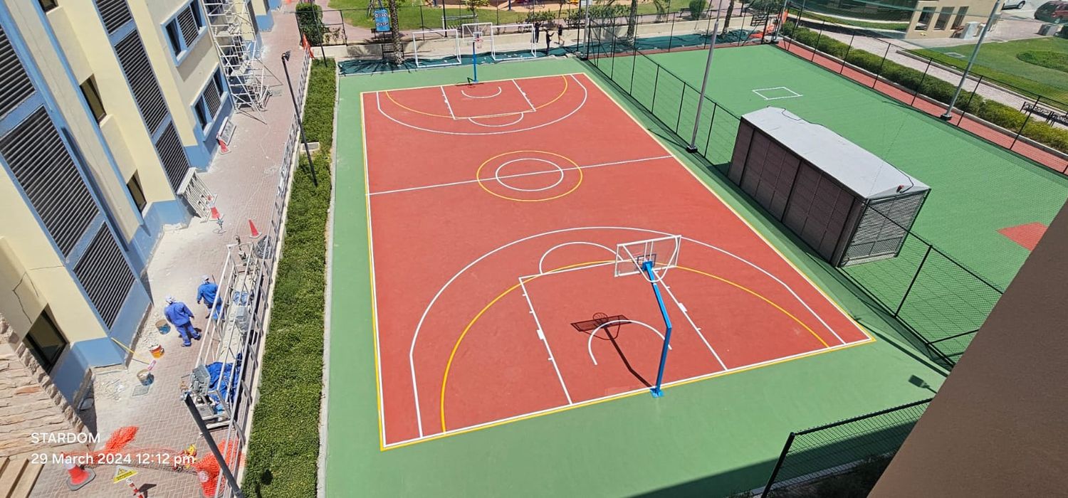 Rooftop basketball court in red acrylic with yellow and white line marking