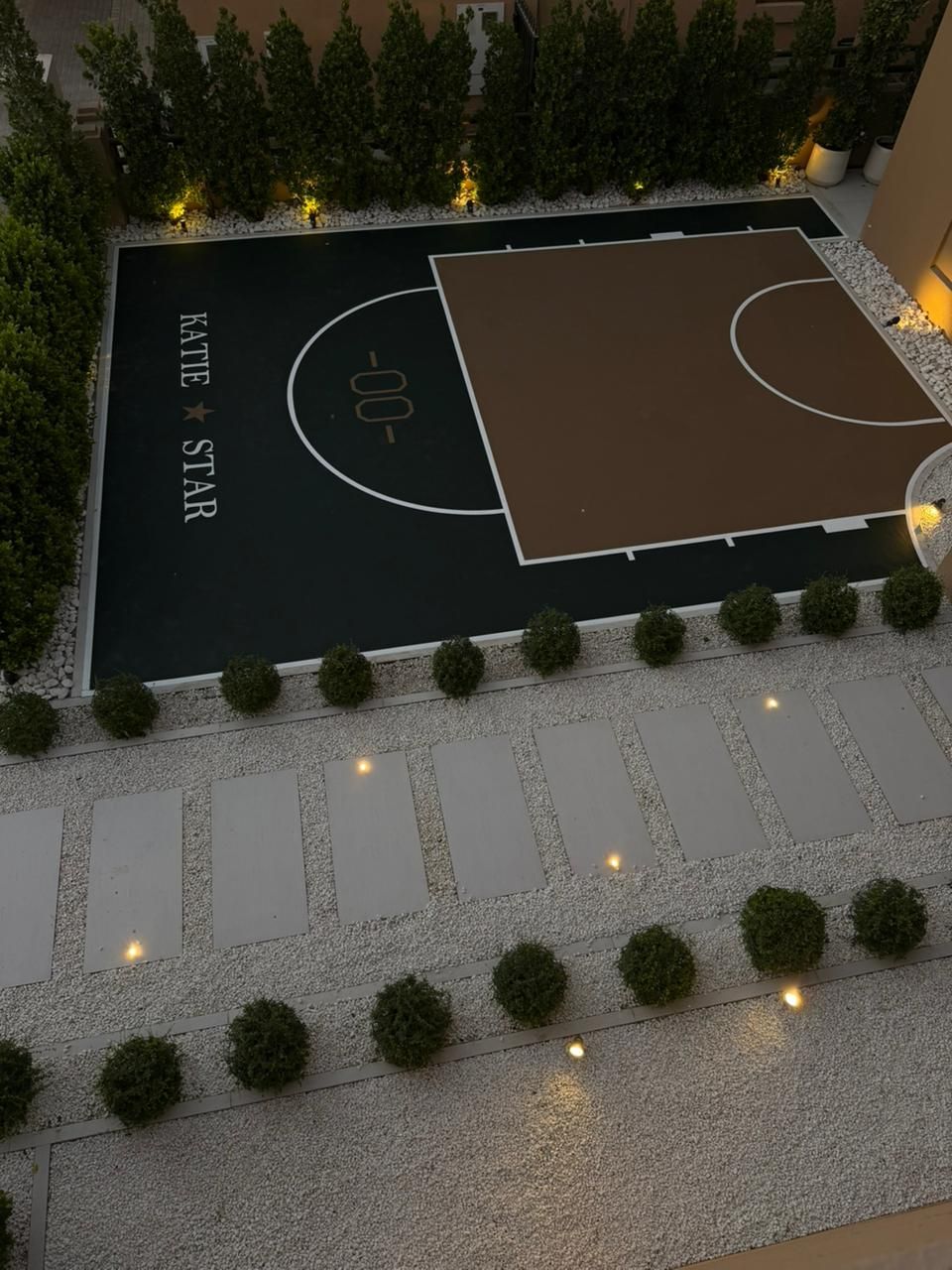 Villa half basketball court in dark green and tan with custom court branding