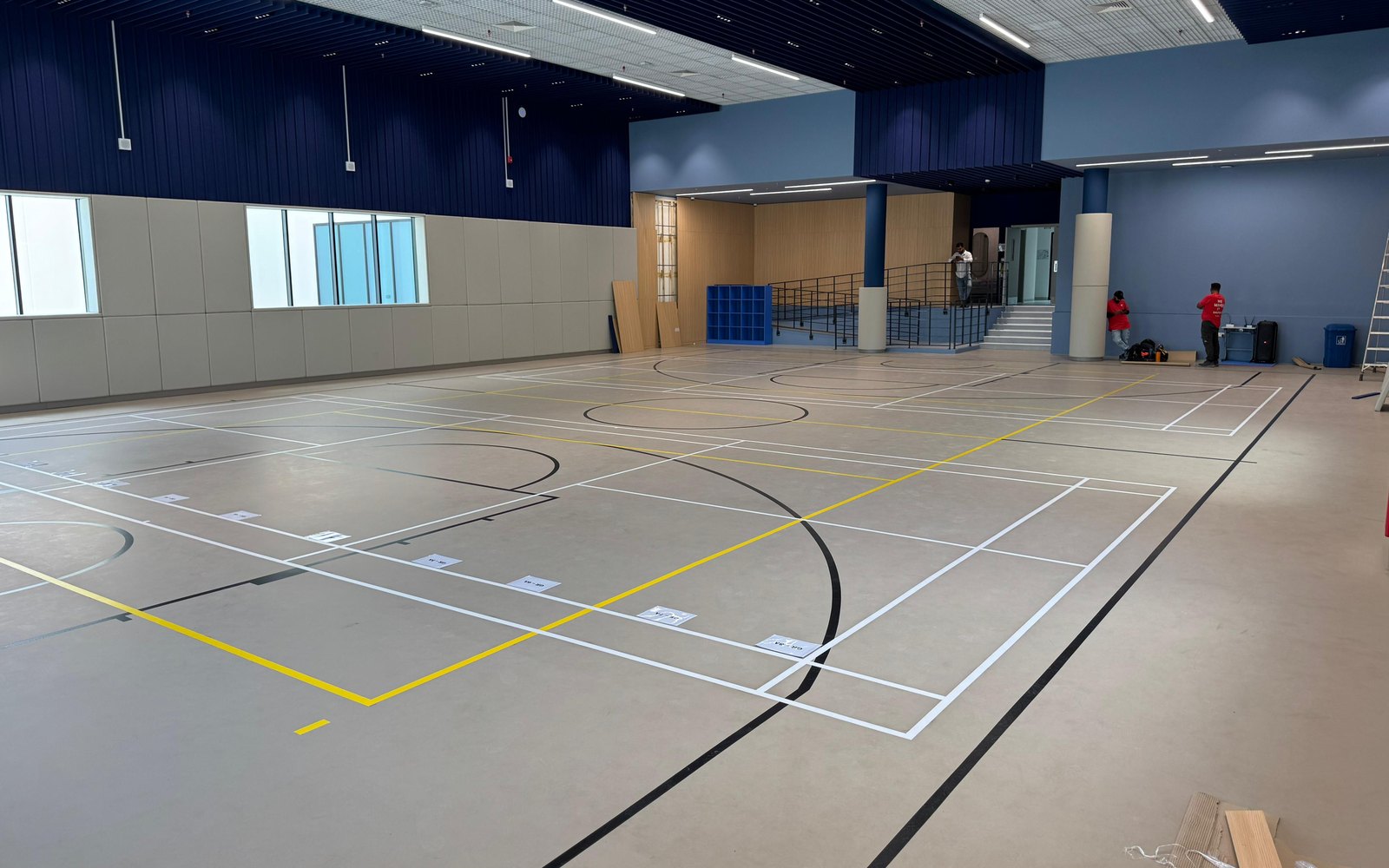 Large indoor sports hall with seamless polyurethane flooring and multi-sport markings